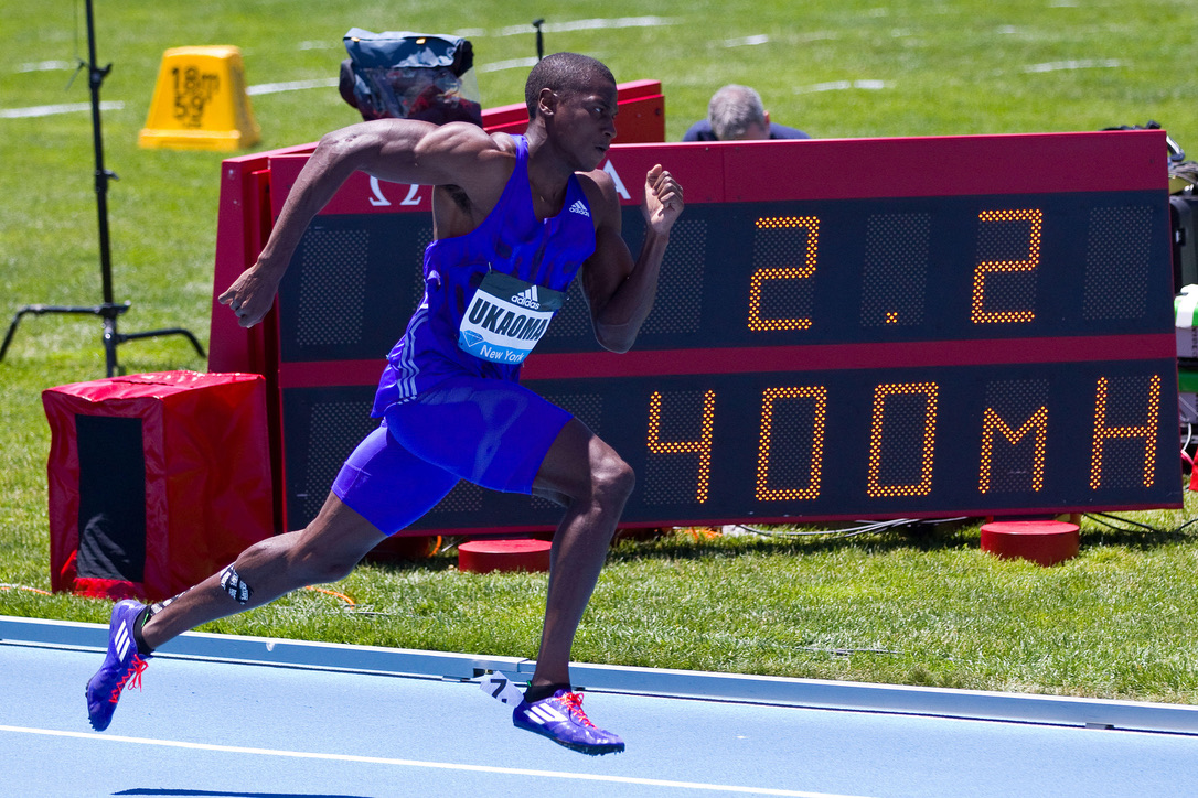 Miles Ukaoma mid-stride as a professional sprinter in Adidas kit